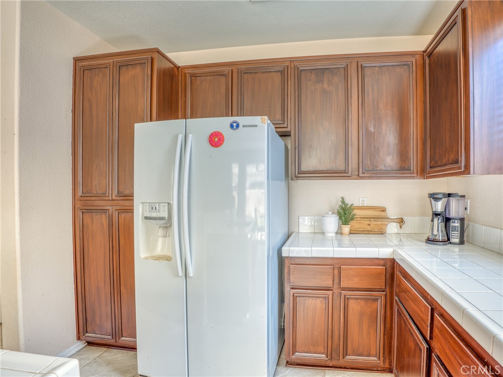 39233 Chantilly Lane Palmdale, CA 93551 - Photo 13 of 31 a white refrigerator freezer sitting inside of a kitchen