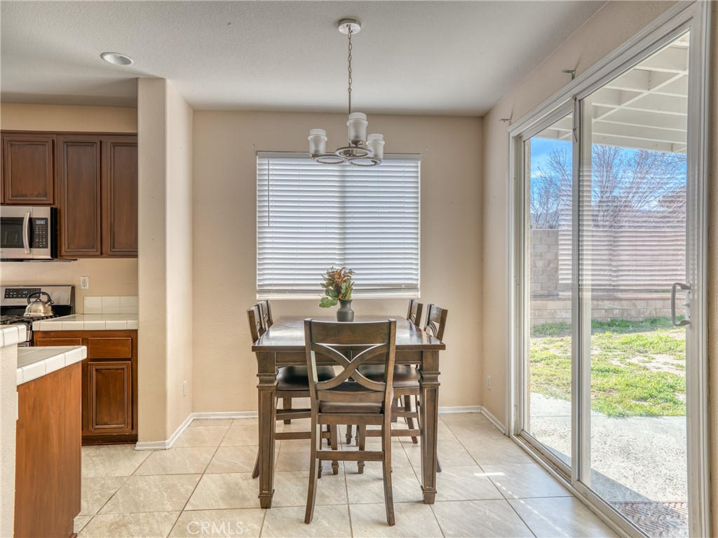 39233 Chantilly Lane Palmdale, CA 93551 - Photo 15 of 31 a dining room with furniture and window