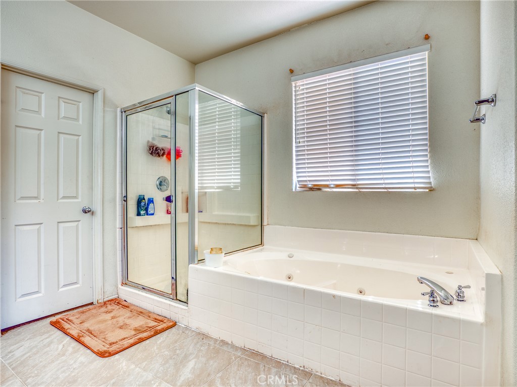 39233 Chantilly Lane Palmdale, CA 93551 - Photo 19 of 31 a bathroom with a tub and a shower