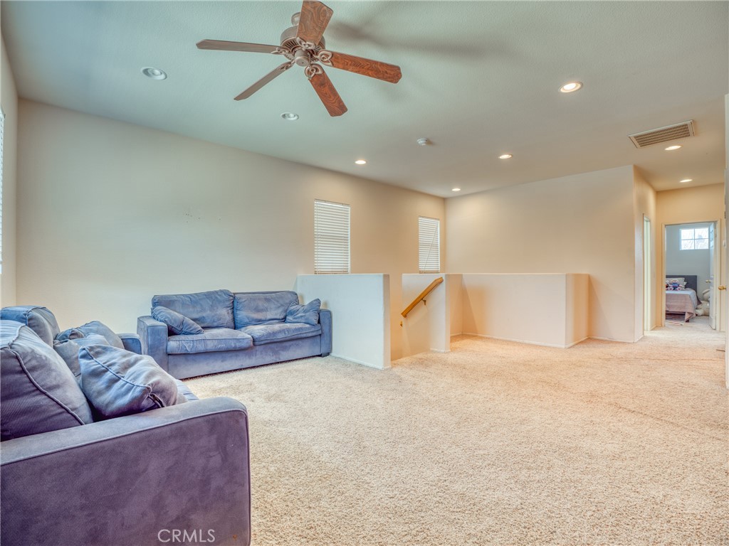 39233 Chantilly Lane Palmdale, CA 93551 - Photo 20 of 31 a living room with furniture and a ceiling fan