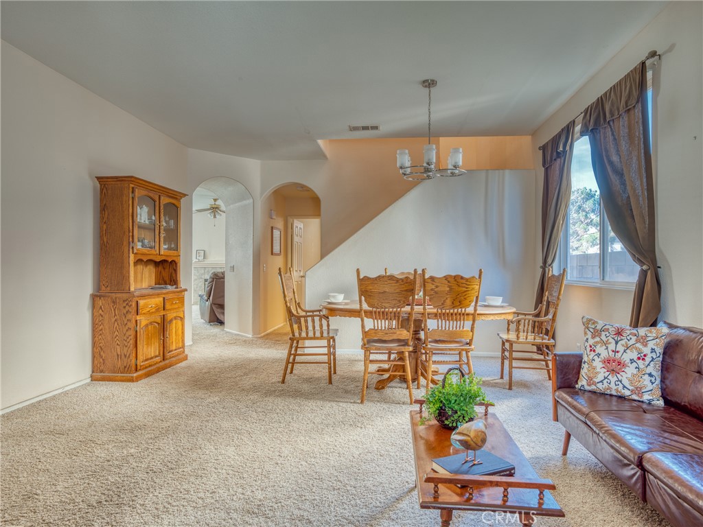 39233 Chantilly Lane Palmdale, CA 93551 - Photo 2 of 31 a living room with furniture a dining table and a potted plant