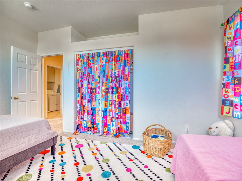 39233 Chantilly Lane Palmdale, CA 93551 - Photo 21 of 31 a bedroom with a bed and a small place