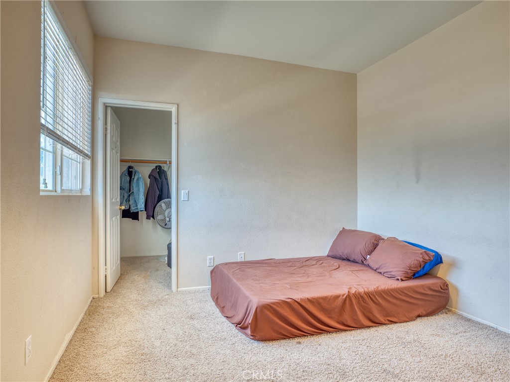39233 Chantilly Lane Palmdale, CA 93551 - Photo 22 of 31 a bedroom with a bed and a window
