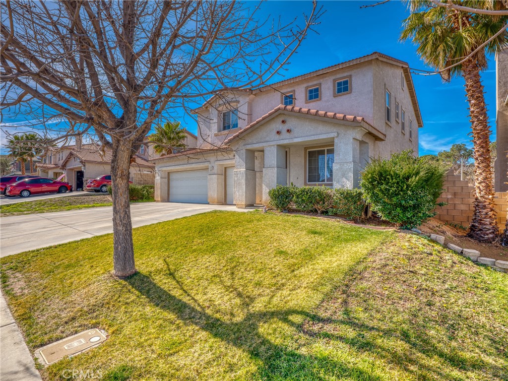 39233 Chantilly Lane Palmdale, CA 93551 - Photo 26 of 31 a front view of a house with garden