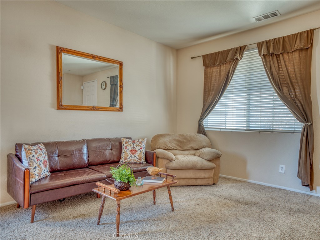 39233 Chantilly Lane Palmdale, CA 93551 - Photo 3 of 31 a living room with furniture and a window