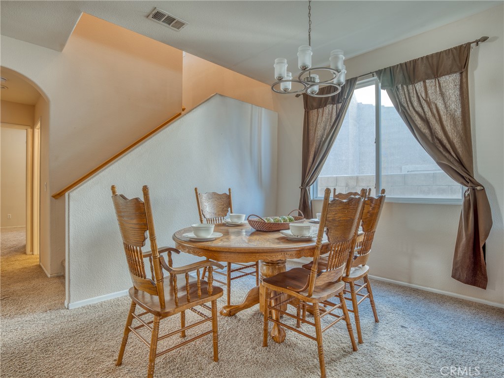 39233 Chantilly Lane Palmdale, CA 93551 - Photo 5 of 31 a view of a dining room with furniture and wooden floor