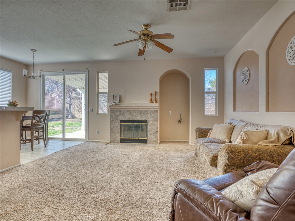 39233 Chantilly Lane Palmdale, CA 93551 - Photo 8 of 31 a living room with furniture and a fireplace