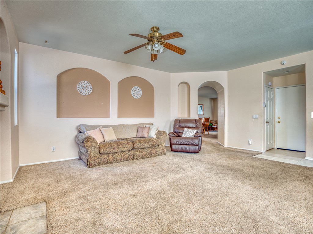 39233 Chantilly Lane Palmdale, CA 93551 - Photo 10 of 31 a living room with furniture and a ceiling fan