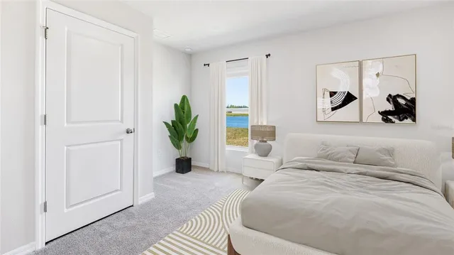 a bedroom with a bed and a painting on the wall