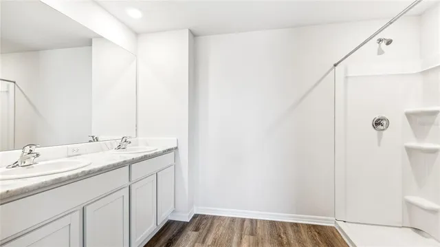 a bathroom with a sink and mirror with toilet
