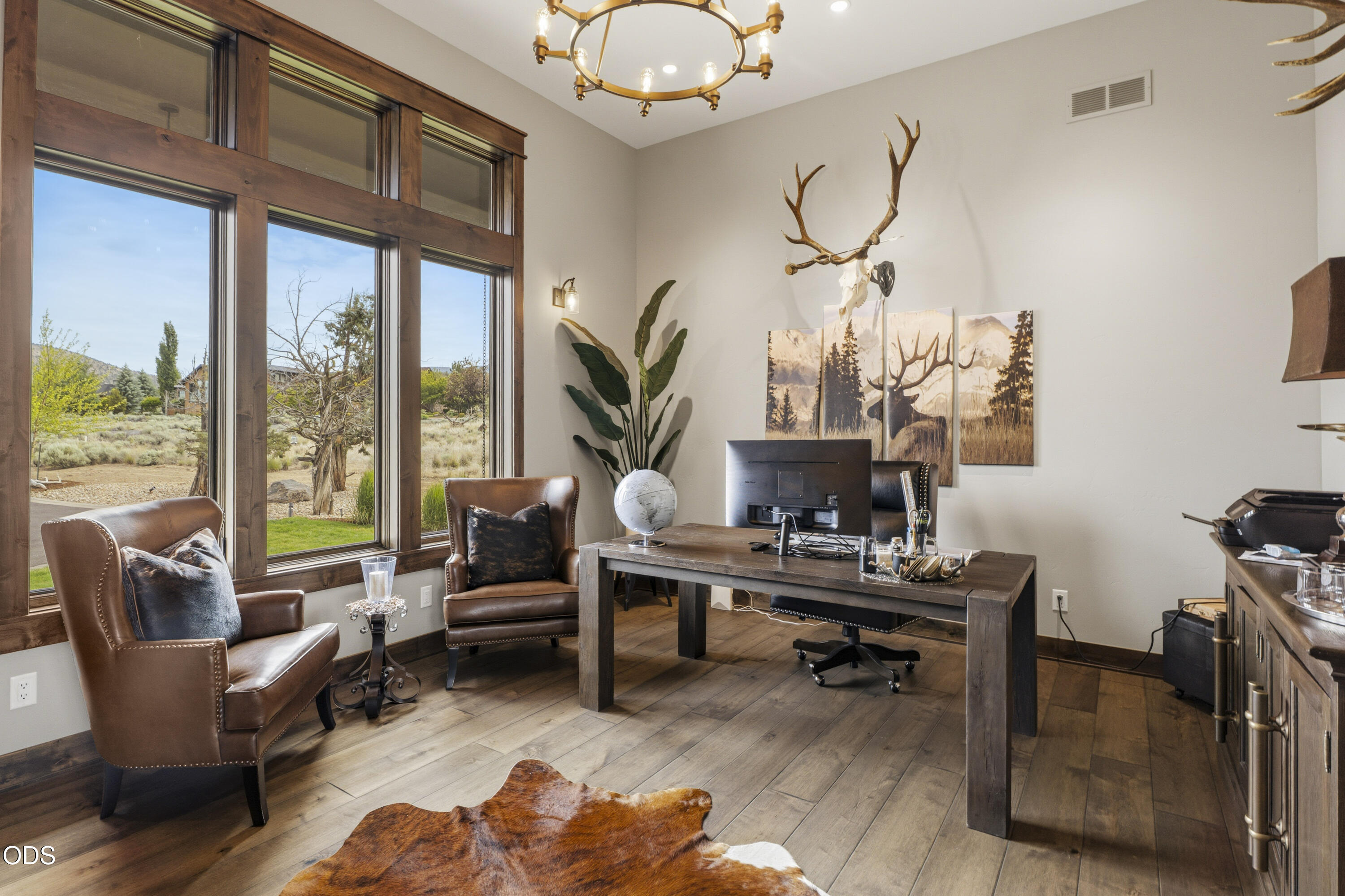 15935 South W Brasada Ranch Road Powell Butte, OR 97753 - Photo 12 of 45 a living room with furniture a chandelier and a floor to ceiling window
