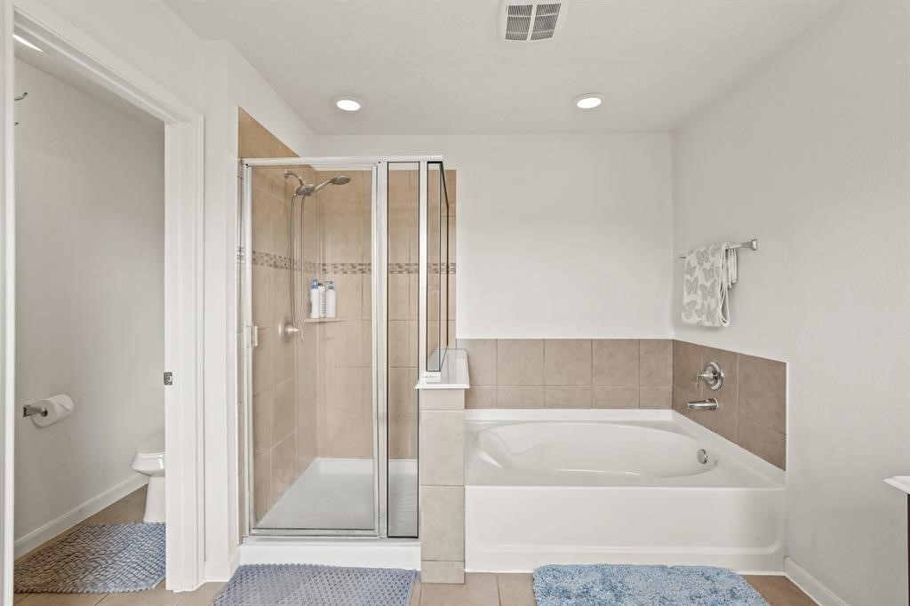 6719 Path Way Court Katy, TX 77449 - Photo 25 of 35 a bathroom with a tub a shower and view