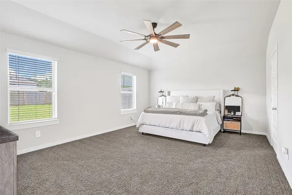 a bedroom with a bed and window