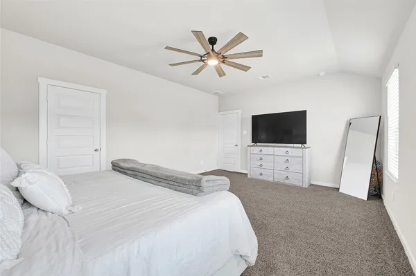 a bedroom with a bed and a flat screen tv