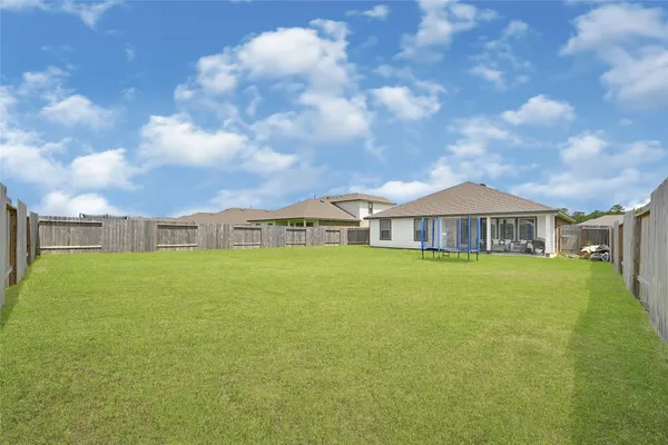 a view of a house with pool and a yard