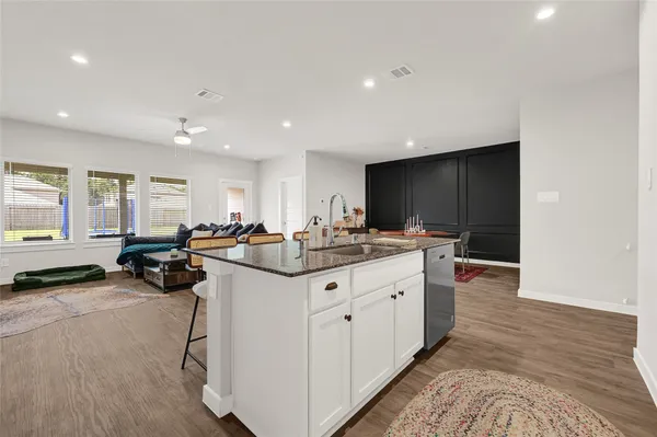 a kitchen with sink stove and refrigerator