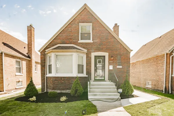 a front view of a house with a yard