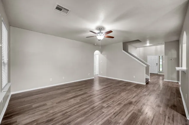 wooden floor in an empty room with a window