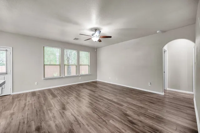 wooden floor in an empty room with a window