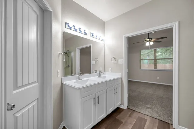 a bathroom with a double vanity sink and a mirror
