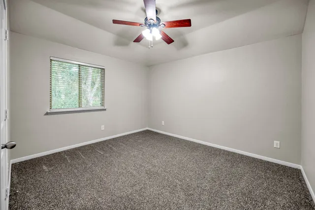 a view of a balcony with floor to ceiling windows and wooden fence
