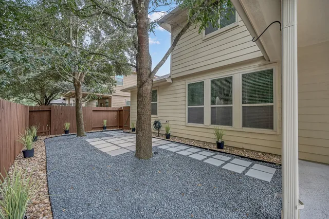 a view of a house with a yard and tree