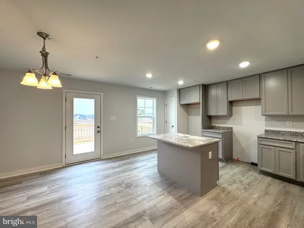 a kitchen with refrigerator and cabinets
