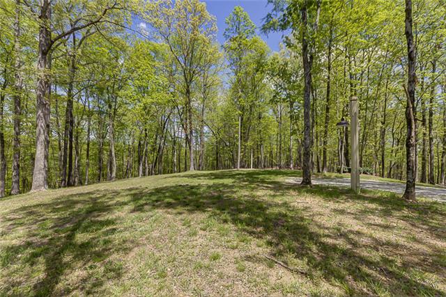 2890 Webb Hollow Road Williamsport, TN 38487 - Photo 18 of 20 The North Ridge Cottage site sits uphill, surrounded by trees.