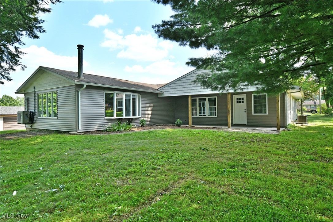 7655 Connelly Road Masury, OH 44438 - Photo 45 of 46 Rear view of house featuring a lawn and a patio area