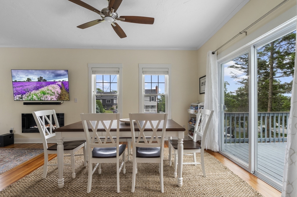 21 Little Nahant Road Nahant, MA 01908 - Photo 10 of 35 a dining room with furniture a flat screen tv and a floor to ceiling window