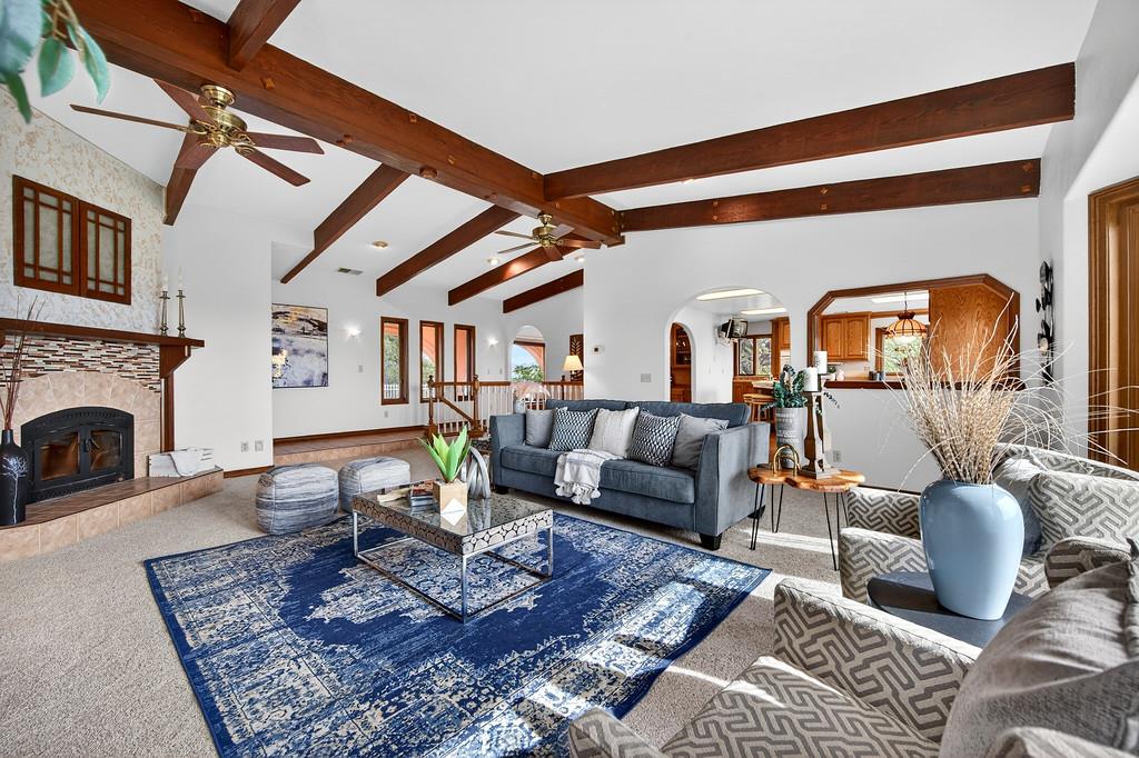 7730 McCourtney Road Lincoln, CA 95648 - Photo 19 of 99 a living room with furniture a rug and a fireplace
