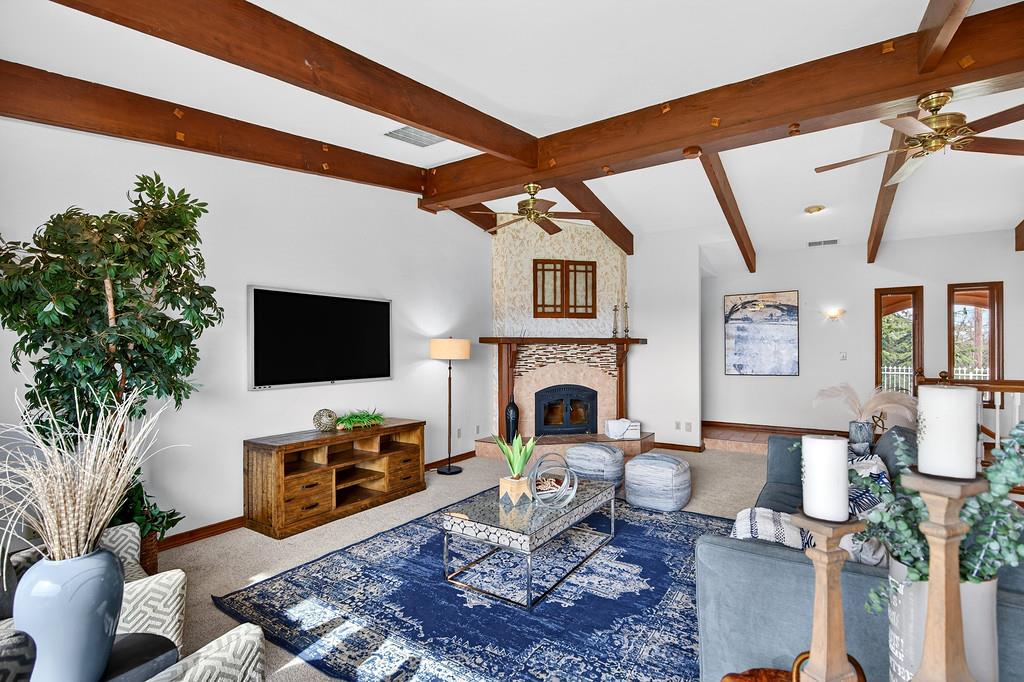 7730 McCourtney Road Lincoln, CA 95648 - Photo 31 of 99 a living room with furniture a flat screen tv and a fireplace