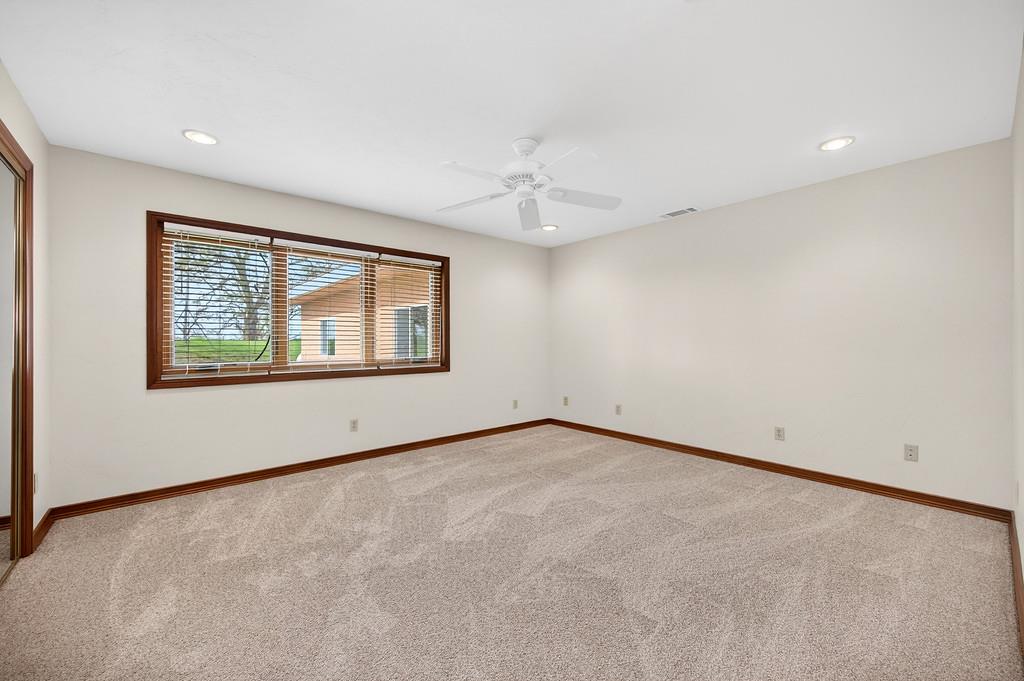 7730 McCourtney Road Lincoln, CA 95648 - Photo 42 of 99 an empty room with windows and ceiling fan