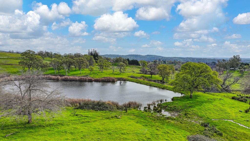 7730 McCourtney Road Lincoln, CA 95648 - Photo 90 of 99 a view of a lake with houses in the back