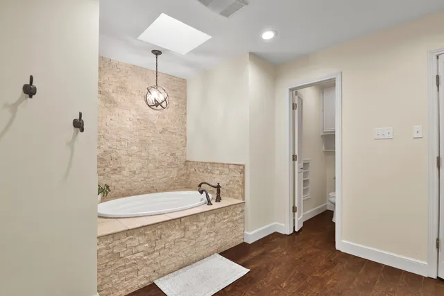 a bathroom with a tub a sink and a shower