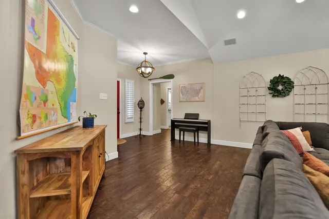 a living room with furniture and wooden floor