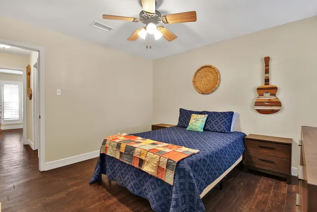 a bedroom with a bed and wooden floor