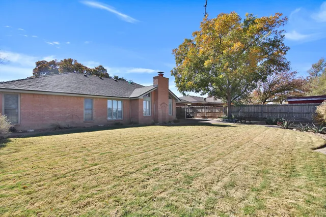 a view of large house with a yard
