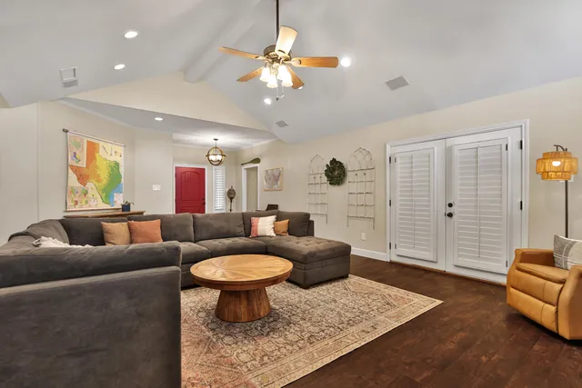 a living room with furniture a rug and a chandelier
