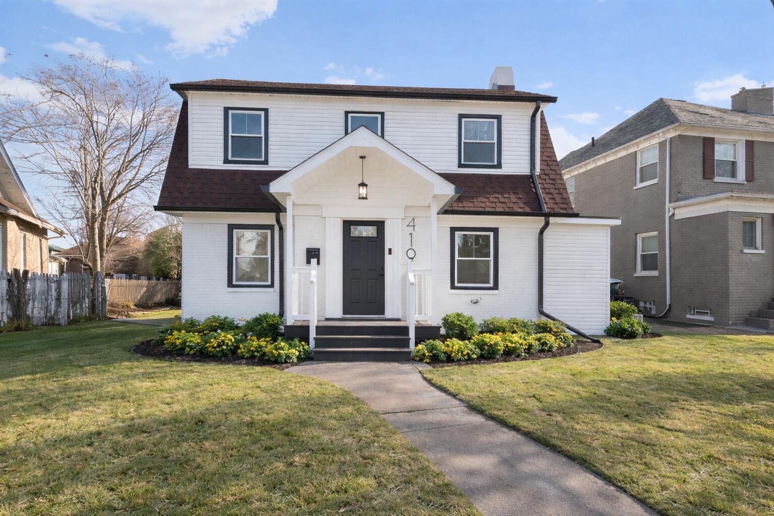 a front view of a house with a yard