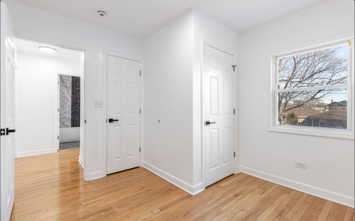 419 Cleveland Street Gary, IN 46404 - Photo 22 of 42 a view of an empty room with wooden floor and a window