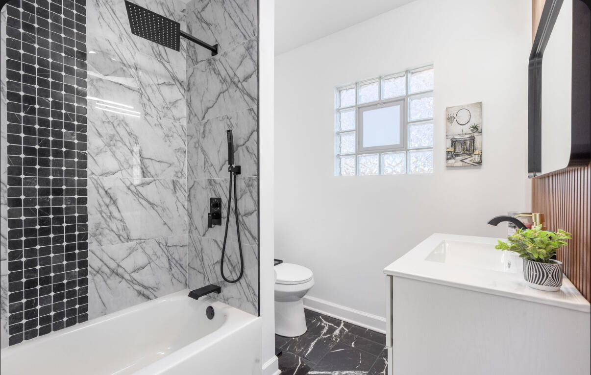 419 Cleveland Street Gary, IN 46404 - Photo 24 of 42 a bathroom with a sink a toilet and a bathtub