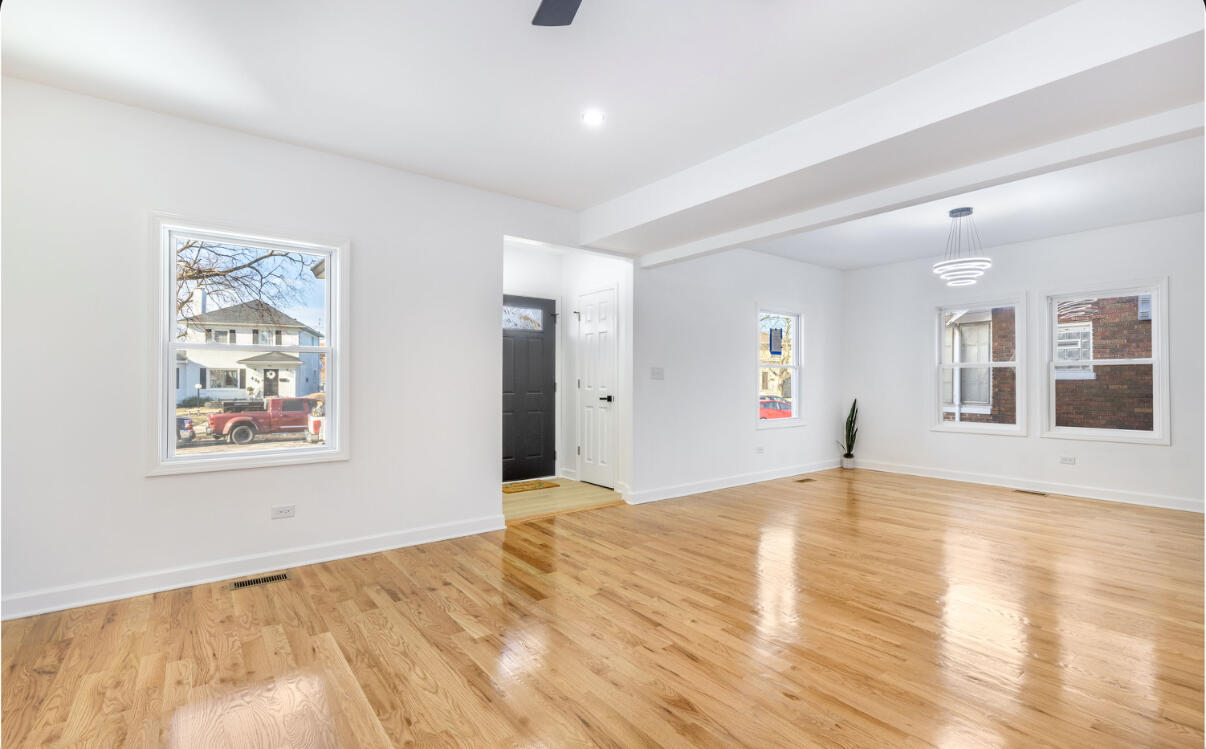 419 Cleveland Street Gary, IN 46404 - Photo 5 of 42 a view of an empty room with window and wooden floor