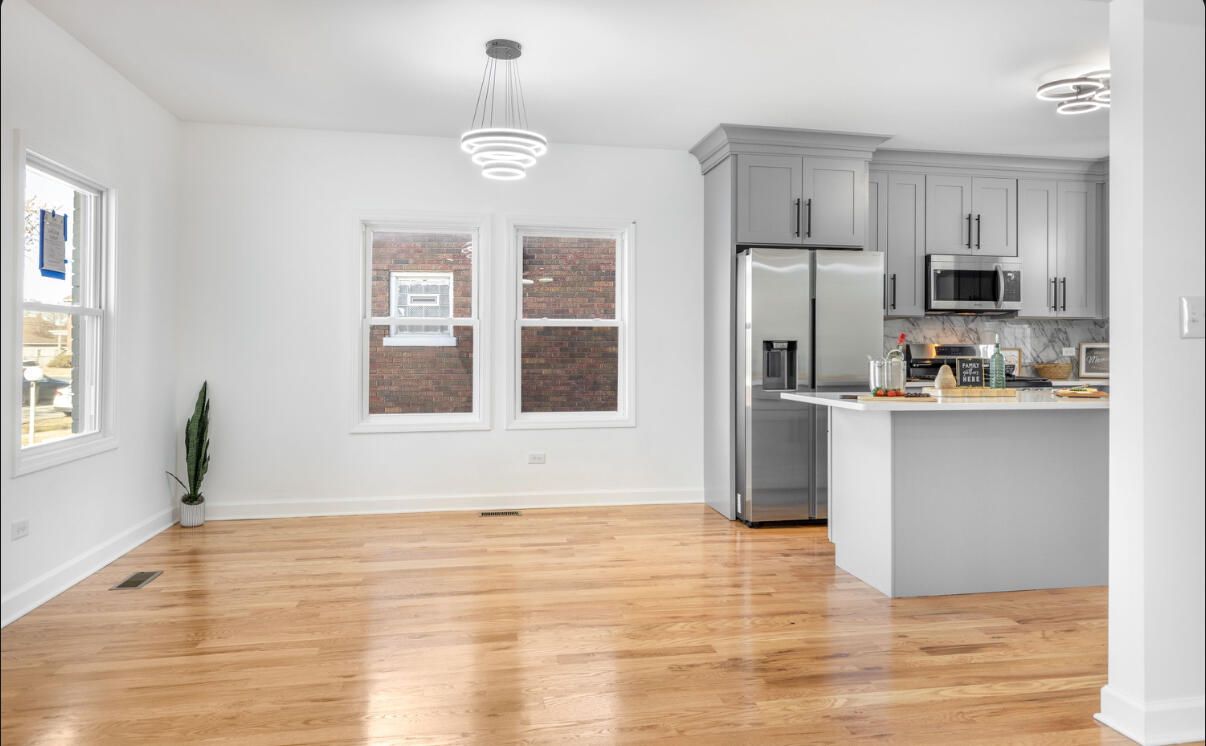 419 Cleveland Street Gary, IN 46404 - Photo 8 of 42 a view of kitchen with cabinets appliances and wooden floor