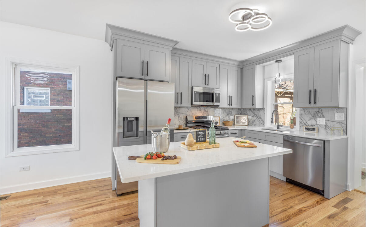 419 Cleveland Street Gary, IN 46404 - Photo 10 of 42 a kitchen with a sink a stove and refrigerator