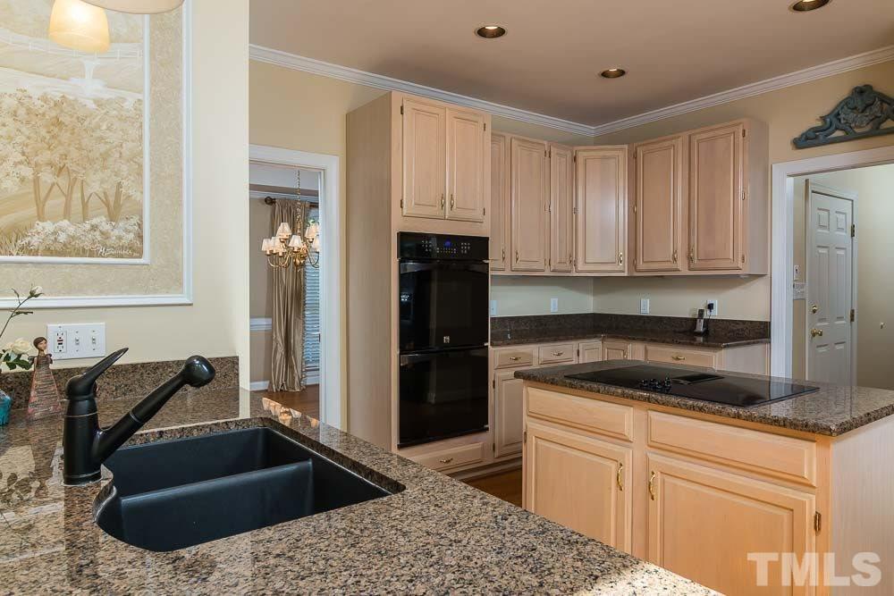 7525 Hazelhurst Circle Apex, NC 27502 - Photo 11 of 25 a kitchen with a sink stove and refrigerator