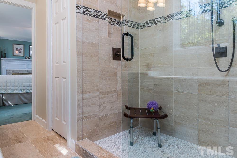 7525 Hazelhurst Circle Apex, NC 27502 - Photo 16 of 25 a bathroom with a shower and a table