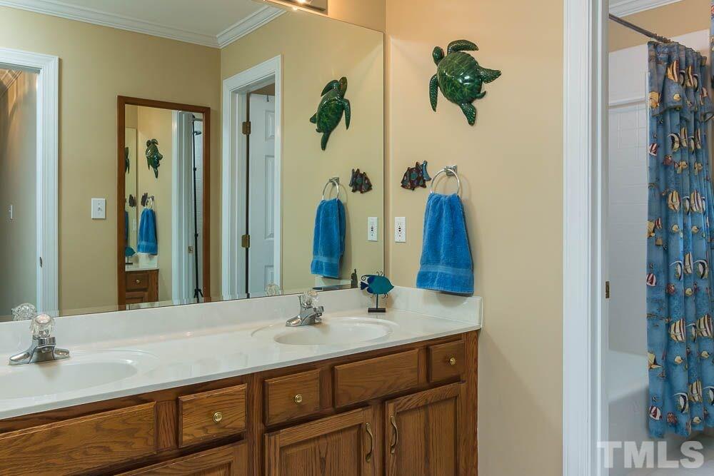 7525 Hazelhurst Circle Apex, NC 27502 - Photo 19 of 25 a bathroom with a double vanity sink and a mirror