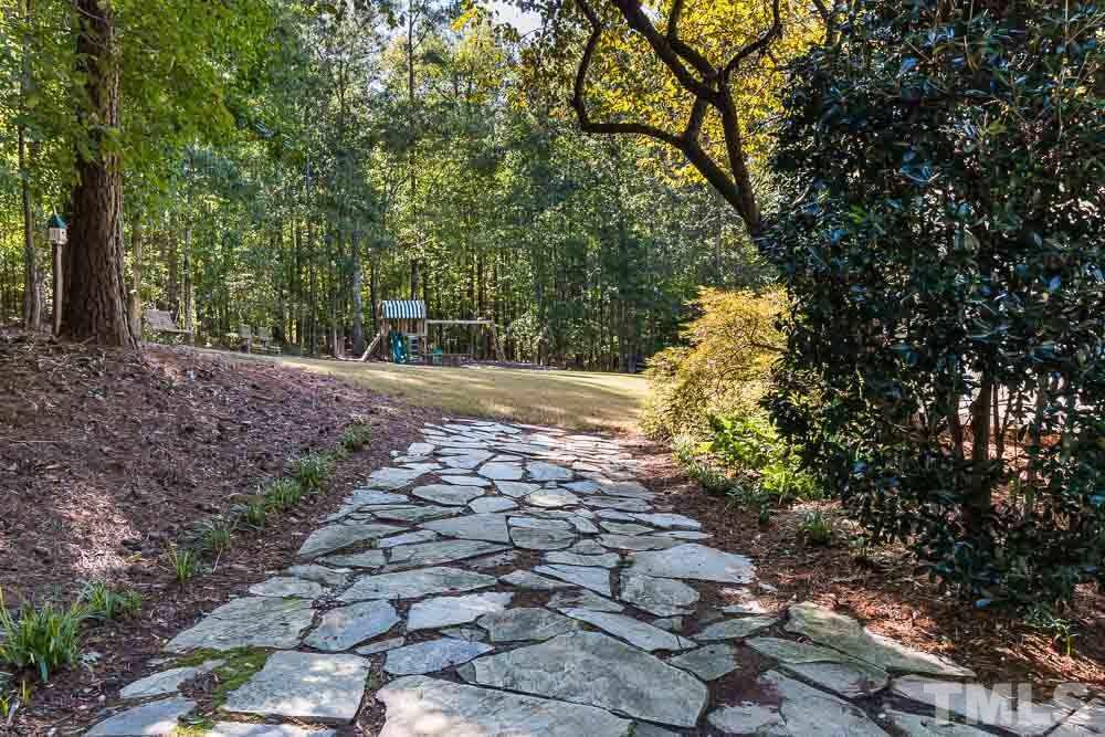 7525 Hazelhurst Circle Apex, NC 27502 - Photo 24 of 25 a view of a yard with plants and large trees
