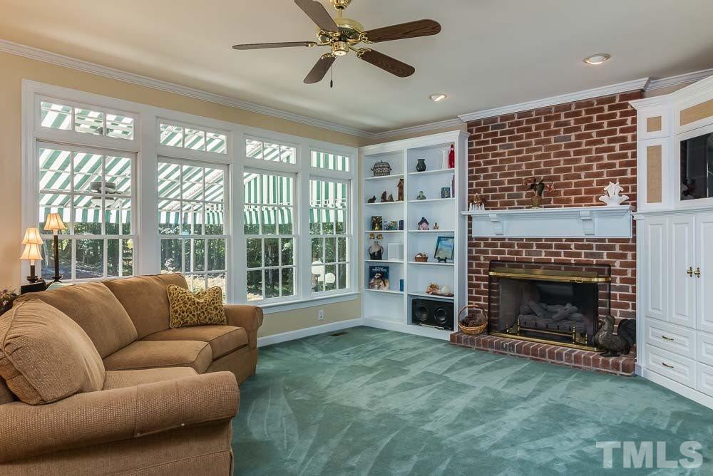 7525 Hazelhurst Circle Apex, NC 27502 - Photo 6 of 25 a living room with furniture a fireplace and a large window